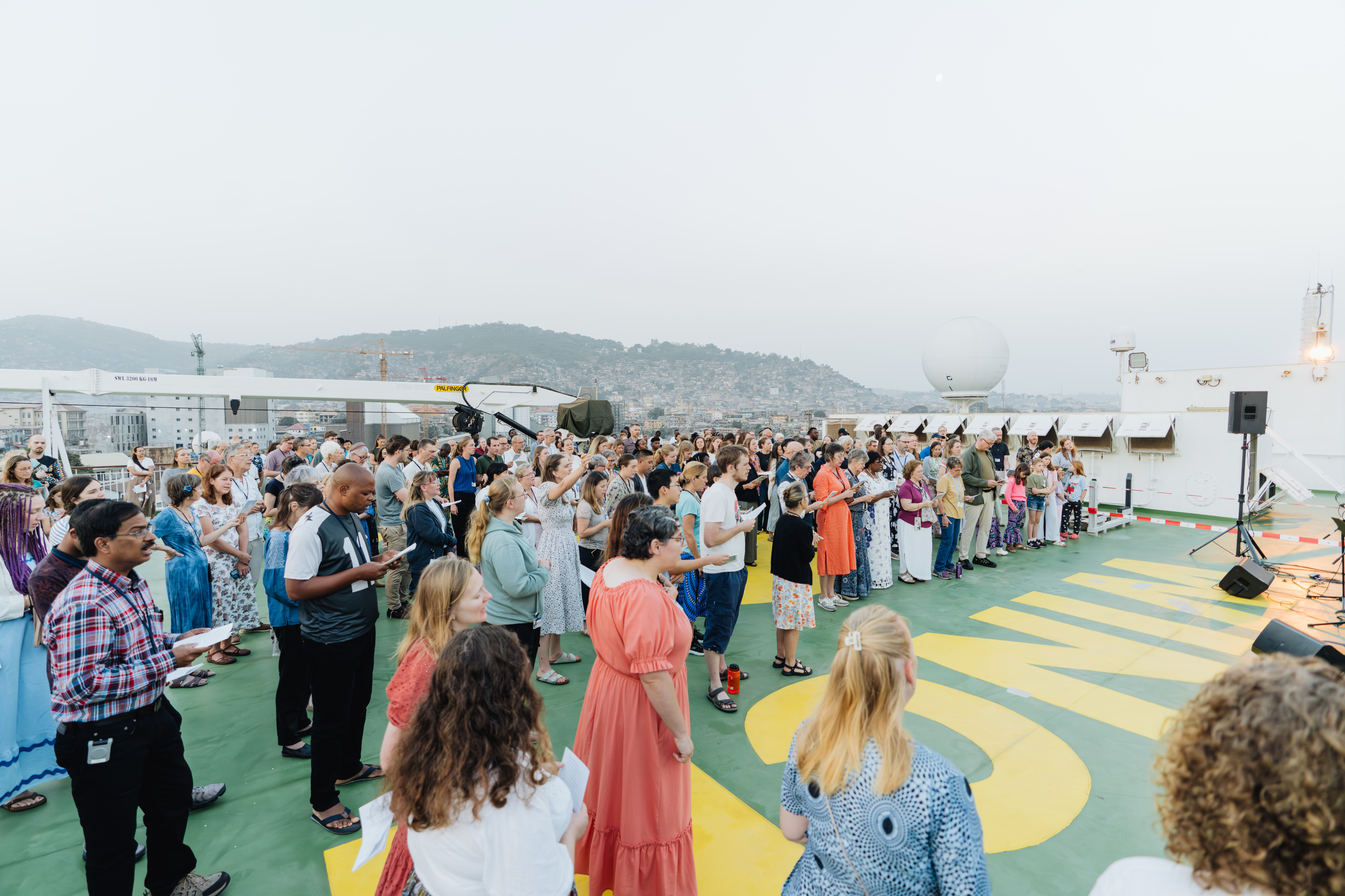 crew participating in the sunrise service onboard on the outside deck.